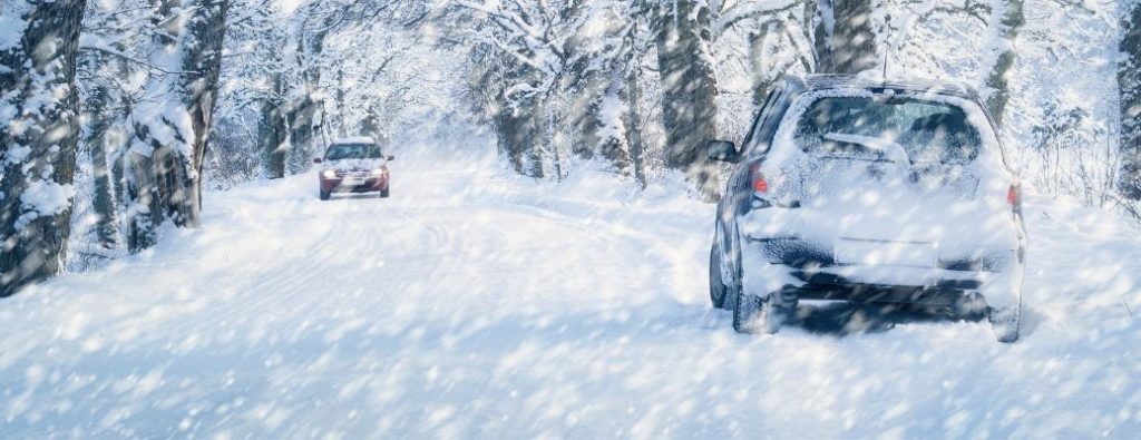 two vehicles on a snowy winter road