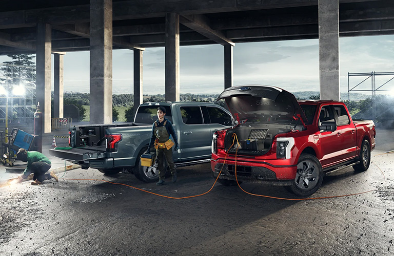 Two Ford F-150 Lightning on a work site