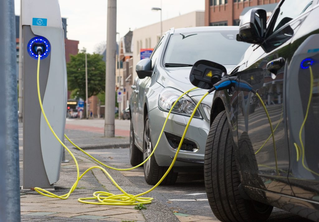 two vehicles charging at a public station