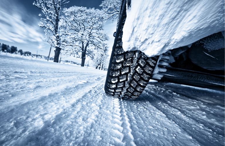 a tire driving on a snow road