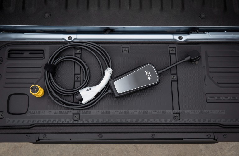 a vehicle charging cord in a truck bed