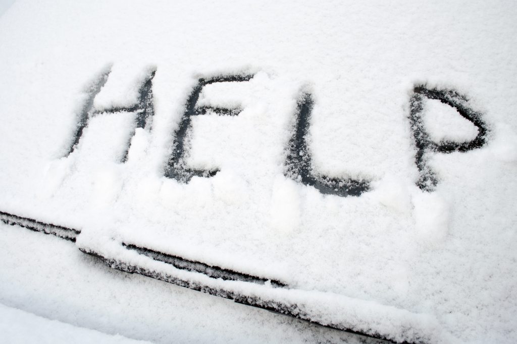 Help written in snow on a car