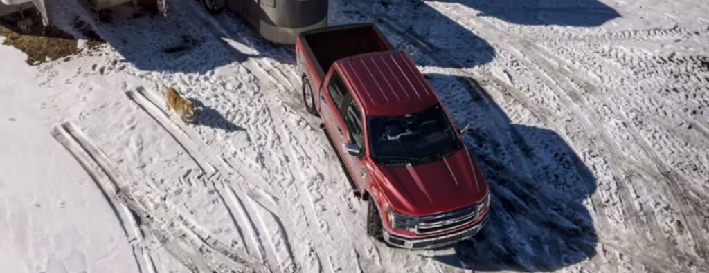 2025 Ford F-150 truck towing a trailer in snow overhead view