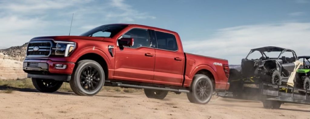 red Ford F-150 towing side view